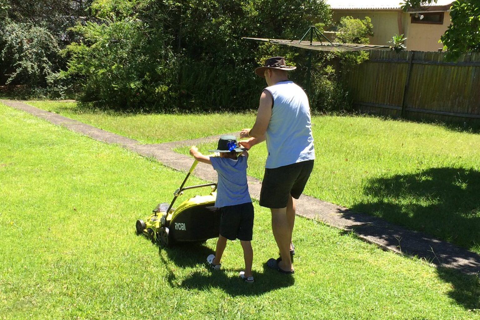 Mower cutting a suburban lawn — lawn mowing service in Christchurch